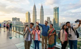 India to Malaysia tour travelers exploring Kuala Lumpur skyline with Petronas Twin Towers in the background